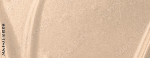 Beige background with a smooth, creamy texture. The background features subtle, flowing patterns in a soft beige color. Minimal abstract gradient curve vector background