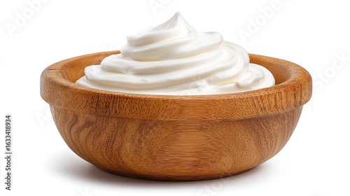 Wooden bowl with swirl of thick whipped cream