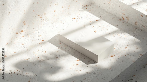 A minimalist, light-filled presentation of a rectangular, white block podium on a speckled, light beige surface.  Shadows and dappled light cast patterns