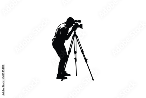 A focused photographer captured in a stark black silhouette standing confidently and operating a professional camera mounted on a sturdy tripod ready to capture the perfect shot