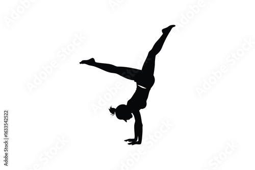 Athletic woman performing a graceful handstand with one leg extended upwards and the other bent showcasing flexibility and strength in a striking silhouette