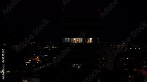 Wallpaper Mural Aerial drone footage captures a vibrant night city bustling with buses and public transport. Illuminated streets and moving vehicles create dynamic urban nightlife scenes.

 Torontodigital.ca