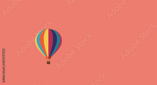 Colorful hot air balloon against a plain coral background