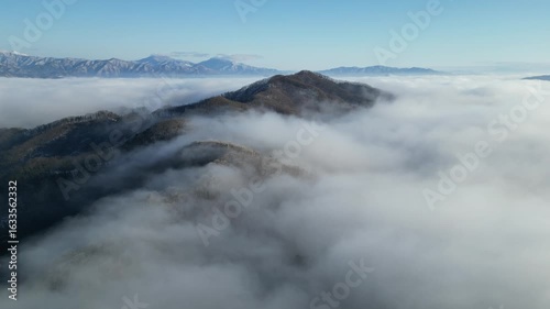 Majestic Mountain Peaks Surrounded by Clouds in Serene Landscape — Korea, winter, drone, snow, sea of clouds, Hohmyeongsan
