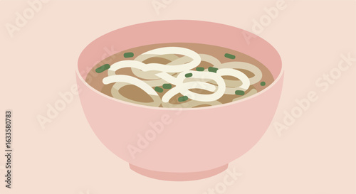 Pink bowl of noodles with green onions on a pale pink background