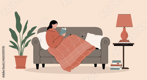 Woman reading on sofa with plant, lamp, and table