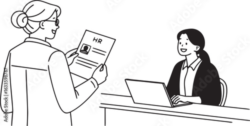 Two women in an office setting one holding an H R document and the other using a laptop interview hiring