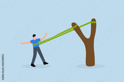 boost career development, The courageous entrepreneur stretches the rubber band in preparation to shoot the slingshot into the air