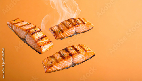 Wallpaper Mural Steaming grilled salmon fillets floating against an orange background. Torontodigital.ca