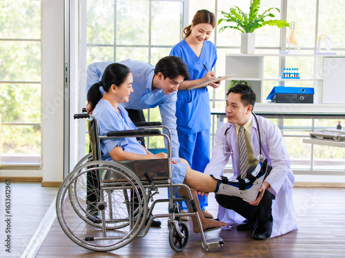 Asian doctor physiotherapy check splint leg support to senior old woman patient assisted by caregiver and nurse medical orthopedic trauma treatment team providing rehabilitation in a healthcare clinic
