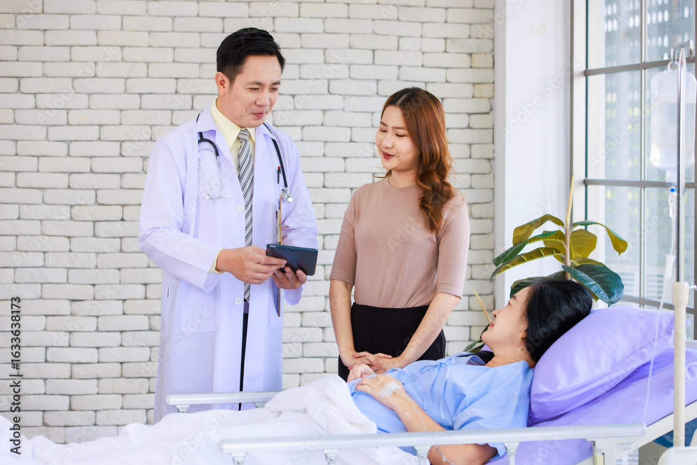 Obraz premium Asian man professional doctor visiting ward, consulting talking explaining medical treatment to lovely daughter family showing healthcare care support while senior woman patient lying on hospital bed.