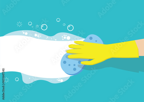 A hand in a yellow rubber glove holds a white foaming cleaning sponge. Focus on the hand and what is being cleaned.