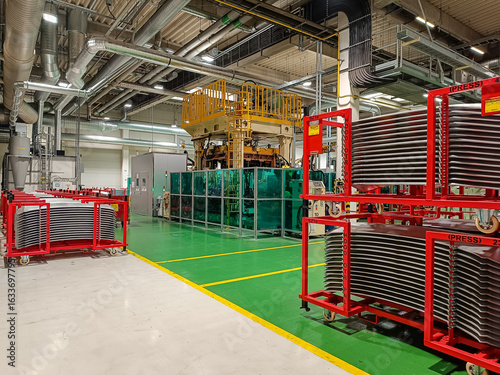 Pallets with manufactured metal parts ready for further processing in an automotive factory