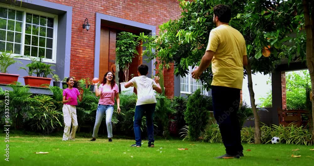 Indian family playing Piggy in the Middle game with ball in lush home garden, enjoying outdoor activity and bonding time, traditional Bich Ka Bandar childhood sport with laughter and fun