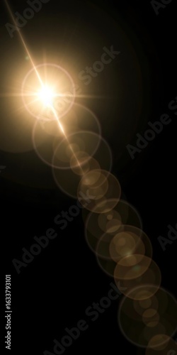 A bright light source with lens flare effect against a dark black background view