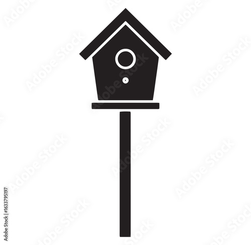 A simple black and white illustration of a birdhouse on a decorative wooden post
