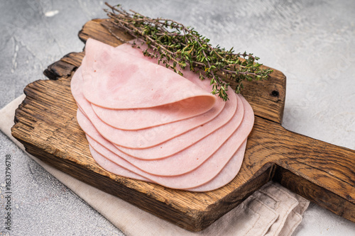 Konstfotografi Delicious slices of cured ham on a wooden platter, ideal for entertaining and adding flavor to your dishes