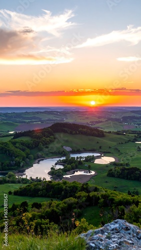Scenic sunset over rolling hills and lakes
