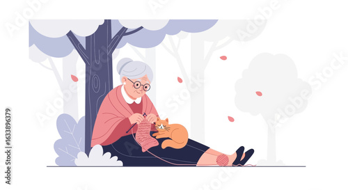Grandmother Knitting Outdoors With Her Cat Underneath a Beautiful Tree in Fall