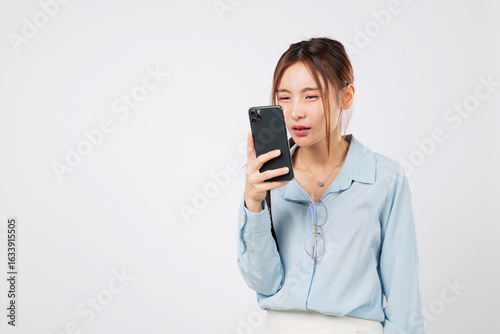 Myopia vision problem. Myopia affects Young Asian woman looking at phone screen closely, eye strain and eyesight loss due to mobile use. isolated studio white background, Poor Eyesight Concept