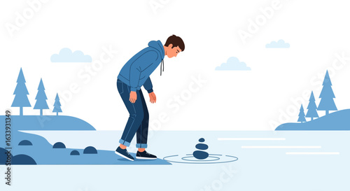 Young Man Contemplating Rock Pile Balance Near Waters Edge In Nature