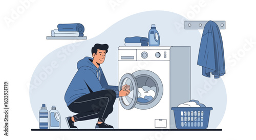 Young Man Loading Clothes Into Washing Machine For Laundry Routine