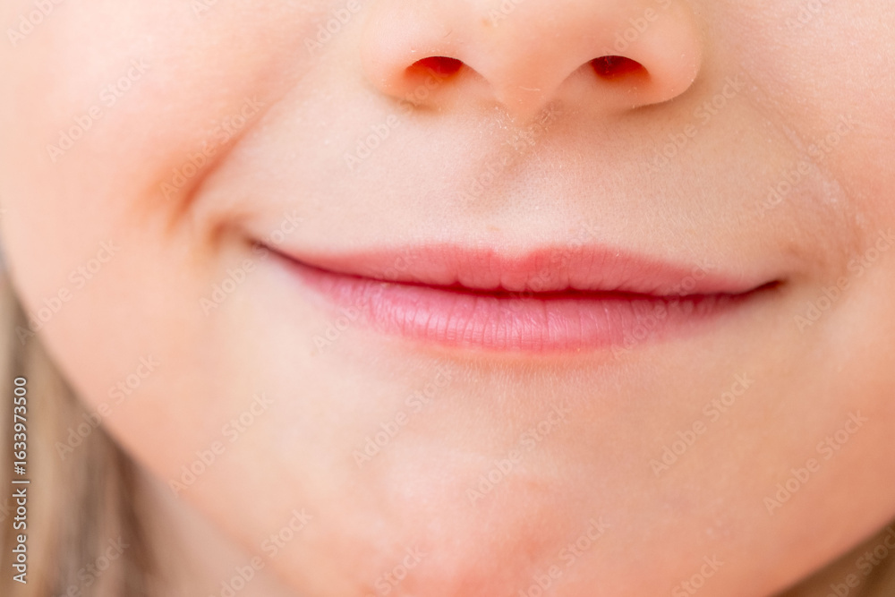 Obraz premium Close-up portrait five year old preschool girl with gentle smile, Childhood happiness, innocent and heartwarming smile, emotional development and empathy skills, Social-emotional learning