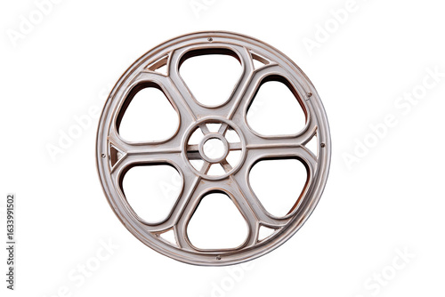 Vintage film reel.  A light beige or cream-colored film reel, circular, with a segmented design.  Each segment is arched with decorative details.  Isolated on black background