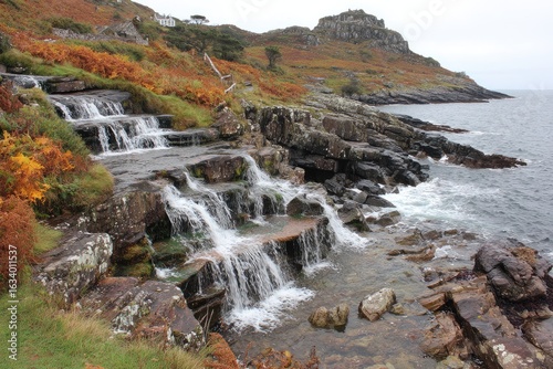 Coastal cascading waterfalls. Autumnal foliage. Rocky shoreline