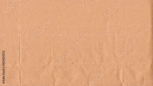 Beige kraft paper noise texture 4K stop motion video. Aged old page overlay effect background loop animation. Vintage paper texture with crease, stain, grain, dust particles. Empty animated backdrop