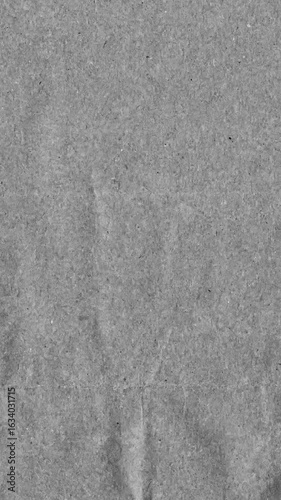 Grey kraft paper noise texture vertical stop motion video. Old page overlay effect background loop animation. Vintage paper texture with crease, stain, grain, dust particles. Empty animated backdrop 