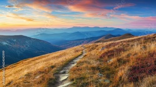 Fototapeta Naklejka Na Ścianę i Meble -  Mountain trail leading along the mountain ridge of beautiful mountains with autumn grass and colorful sky. 