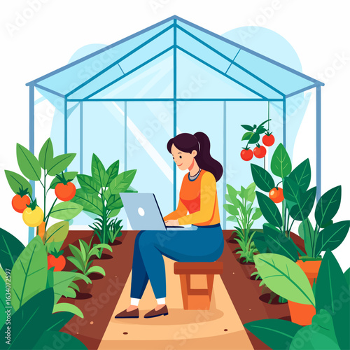 A young woman works on her laptop inside a modern greenhouse, surrounded by lush green plants and ripening tomatoes.