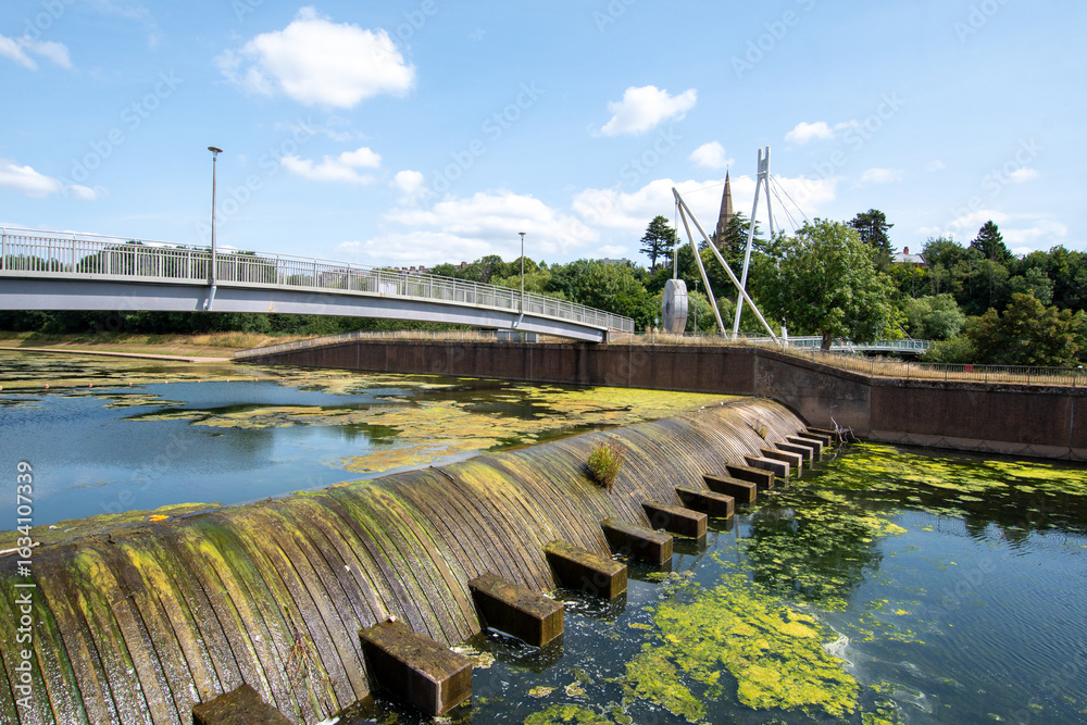 Obraz premium Millers crossing bridge over the river Exe in Exeter. Large mill stones support the structure of the bridge.
