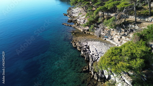 Dugi Otok's rugged stone coast stuns with raw Adriatic beauty—dramatic cliffs, crystal-clear waters, and golden light perfect for breathtaking, timeless photography.