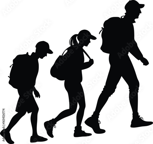 Silhouettes of people hiking with backpacks walking