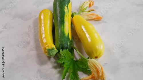 Top view of colorful zucchini on light textured background. Perfect for healthy eating and vegan dishes. Close-up, top view. Organic zucchini, yellow zucchini, green zucchini