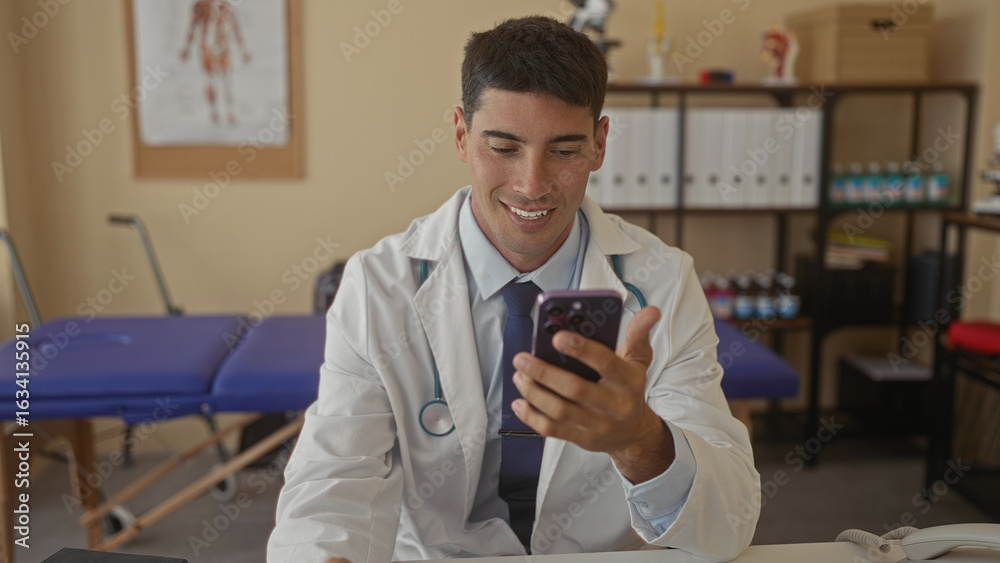 Doctor man in white coat with stethoscope holds smartphone and taps screen at clinic desk; compassion duty. Doctor man in white coat with stethoscope holds smartphone and taps screen at clinic desk; compassion duty.