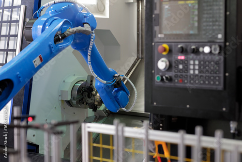 robot loading parts into CNC lathe machine