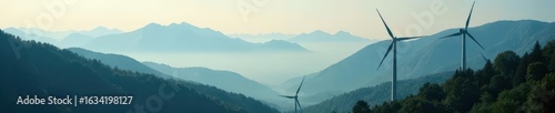 Tall wind turbines pierce misty mountain forest , highland, nature
