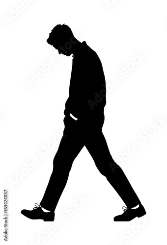 Black silhouette of a man walking with his hands in his pockets and head down, depicting sadness or deep thought, isolated without background