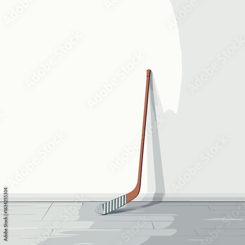 Hockey stick leaning against wall in indoor sporty setting  