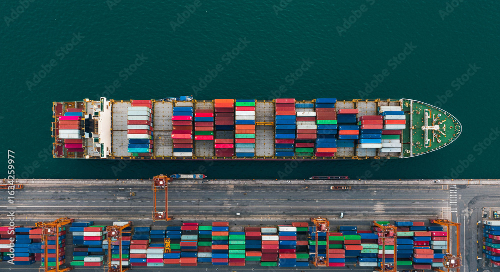 Obraz premium Aerial View of Cargo Ship Loaded with Colorful Containers at Port Terminal