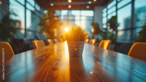 Wallpaper Mural Conference room table with a potted plant in a modern office space bathed in soft sunlight. Torontodigital.ca