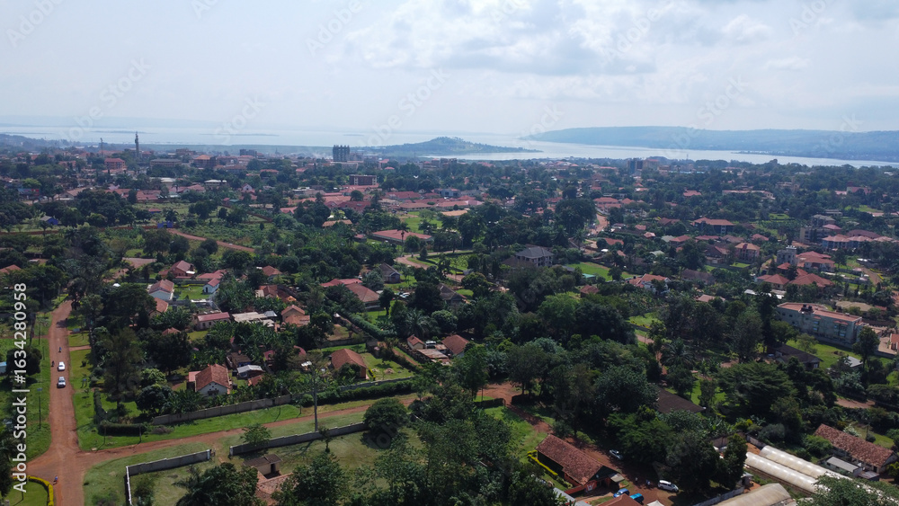 Obraz premium Scenic Aerial View of a Ugandan City with Lake Victoria in the Background.
