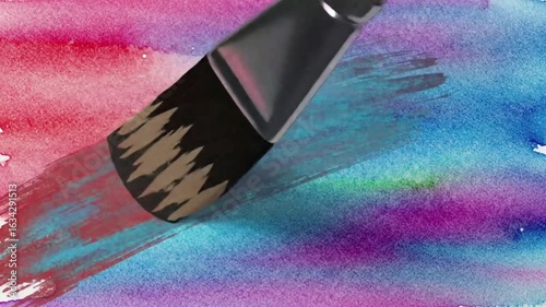 A close-up video of a paintbrush moving across a surface, leaving a beautiful stroke of pastel watercolor paint.
