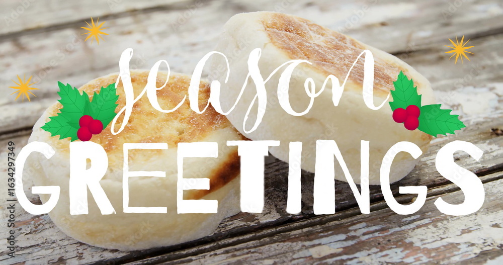 Fototapeta premium Featuring two English muffins on rustic tabletop showing season GREETINGS text with holly and stars