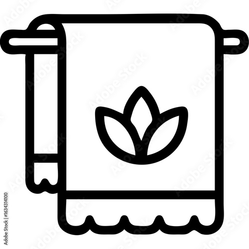 A towel for yoga with a leaf on it. The towel is hanging on a rack