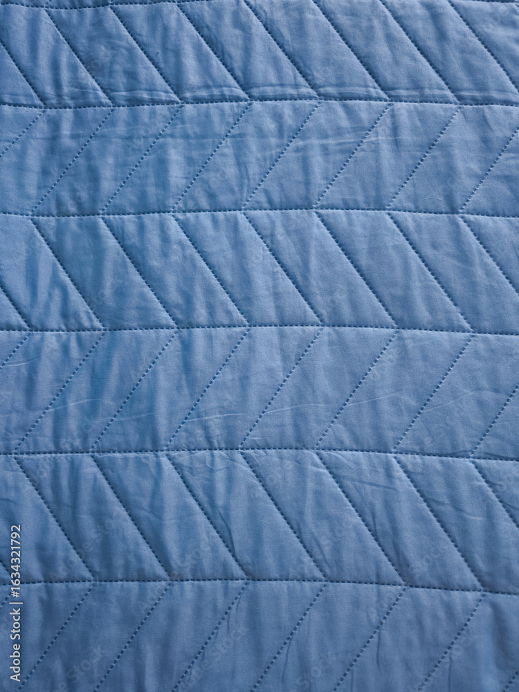Naklejka premium Blue quilted fabric texture creating a diamond pattern background