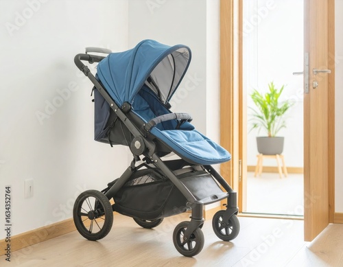 A blue stroller sits inside a home near a doorway, ready for use.